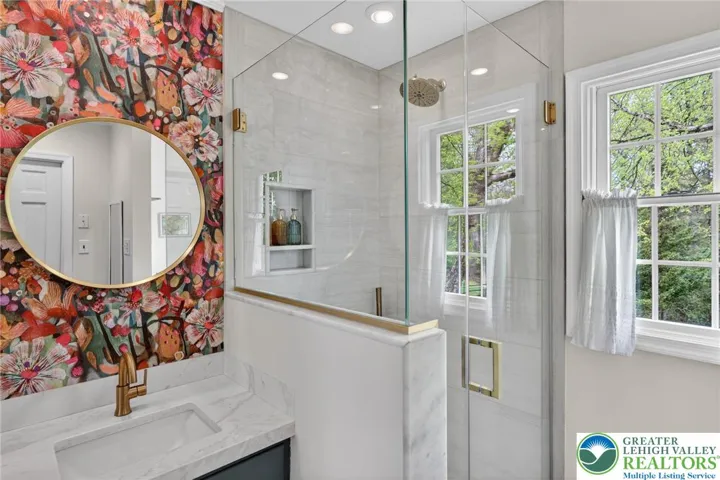 Glass shower; tiled; shaving niche;walk-in closet