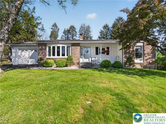 Trees in front moved to side to enhance view of house.