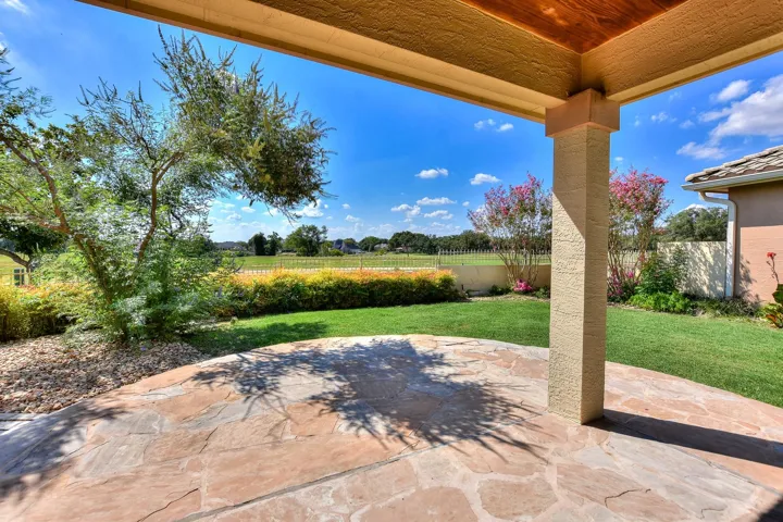 Such a pretty view of the golf course from your stone floor, covered patio. This home has only had one owner....and the owners loved this house....