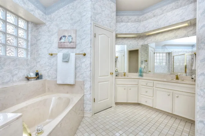 Double vanities on the right....in the center is the door to the water closet...