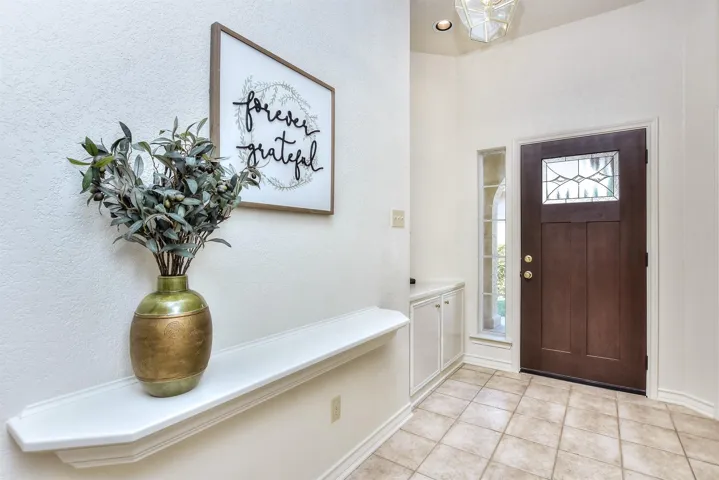 As you enter the front door, there is an art niche to the right and a built in shelf as you come into the formal dining room....
