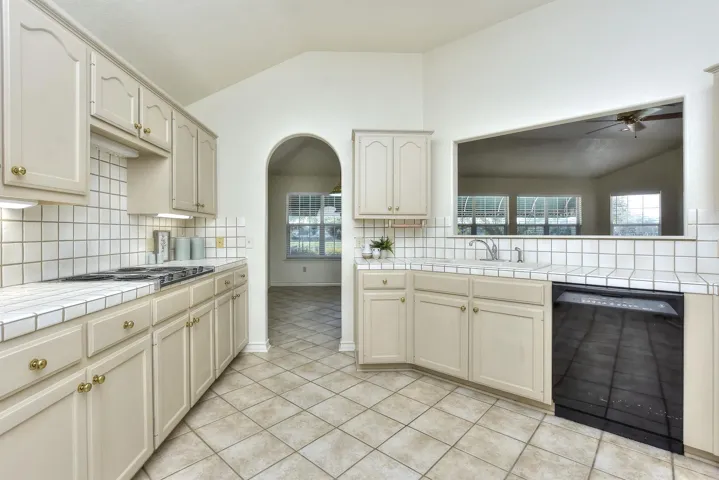 This archway leads to the breakfast area off of the family room....This pass through makes serving the beverages & popcorn through to the family room during football season!