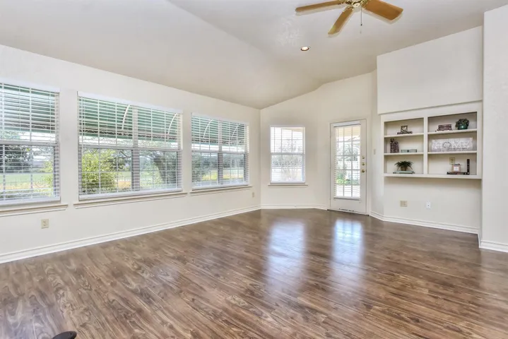 The glass-paned back door leads to the rear covered patio and the back yard...
