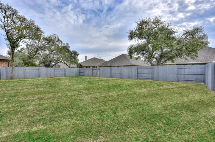Large backyard with newly painted fence