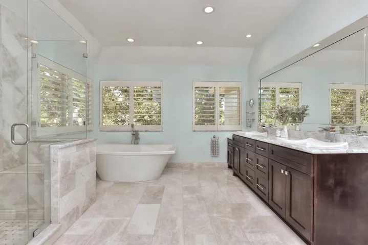 Completely remodeled primary bathroom will surely make you feel pampered & relaxed.  Two walls of windows with Plantation Shutters, marble floors, marble counters, replaced cabinets with a clothes hamper at the end, a whisper jet free standing tub, and a walk-in shower with 4 body jets....Yes...I believe you will be able to relax after this spa-type end to your day...
