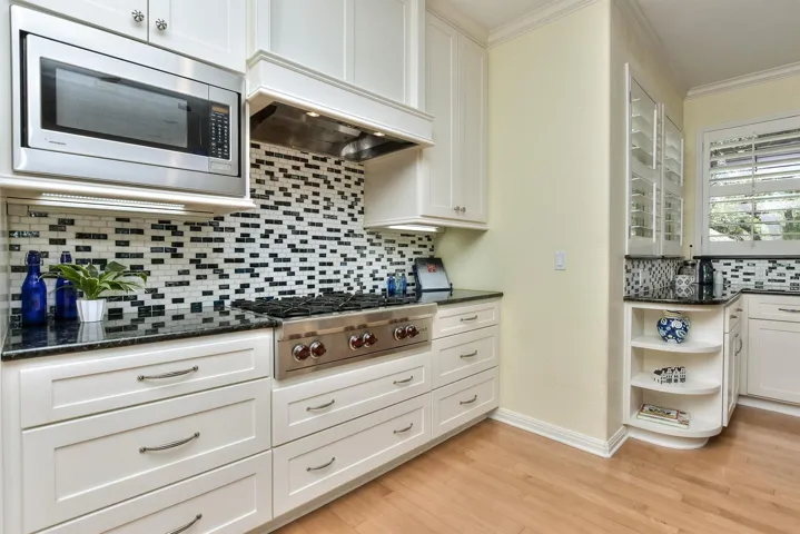 This photo shows you the great drawers for storage...so desirable in the kitchen.  Plus a 6 Burner Wolf brand gas stove-top...