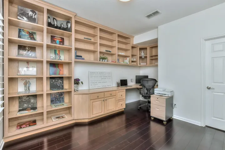 To the immediate left of the front entry is a fully ready, very private office office with a built-in desk & an abundance of shelves & cabinets....