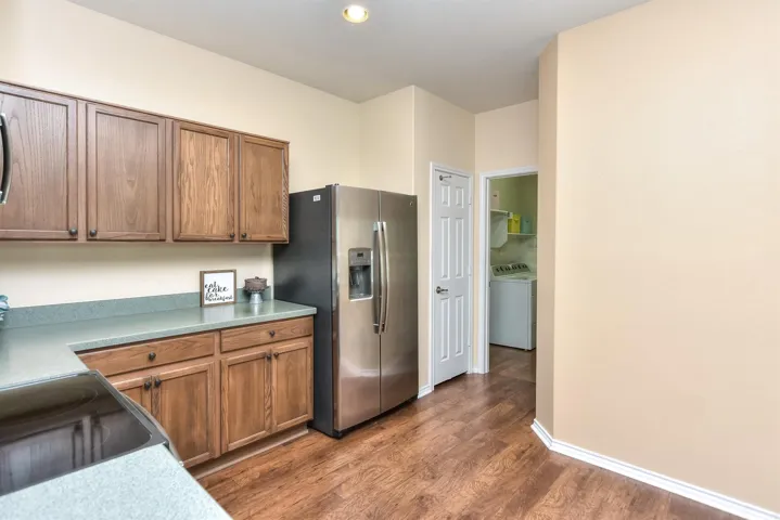 This side of the kitchen features the pantry closet and the doorway to the laundry room & to the 2 car garage...The washer and dryer and refrigerator are all negotiable...