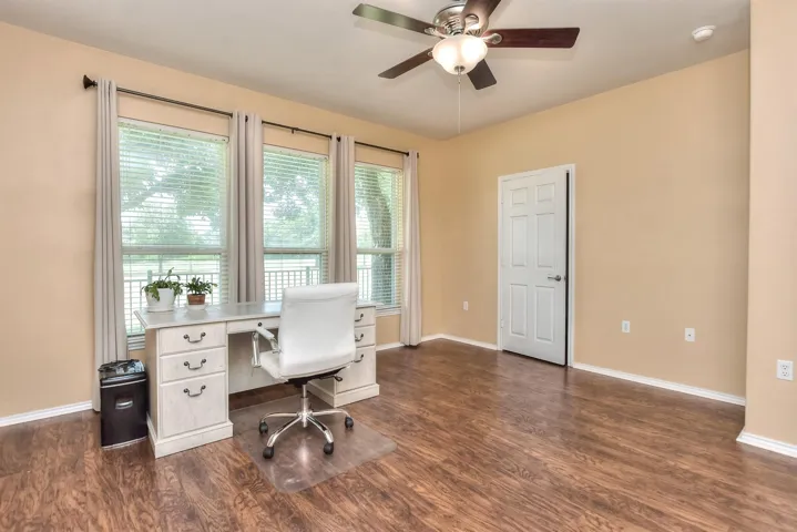 This is the primary bedroom with triple windows for great natural light.  Outside this window is the rear greenbelt & a small wrought iron fenced yard.  Your HOA fee pays for grooming the front and side yard and the greenbelt.  But the backyard must be done by the Ownder or hired out.  The current owner pays TBC Landscaping only $150. + sales tax for ONE YEAR of mowing the backyard.  That service is currently paid through May of 2025 and will convey to you when you buy the home!  