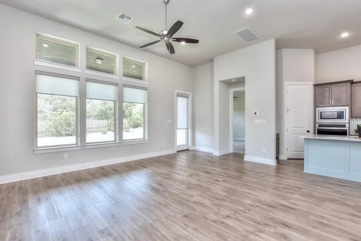 Rear wall of the home in the family room...with a view of the large, covered back patio...