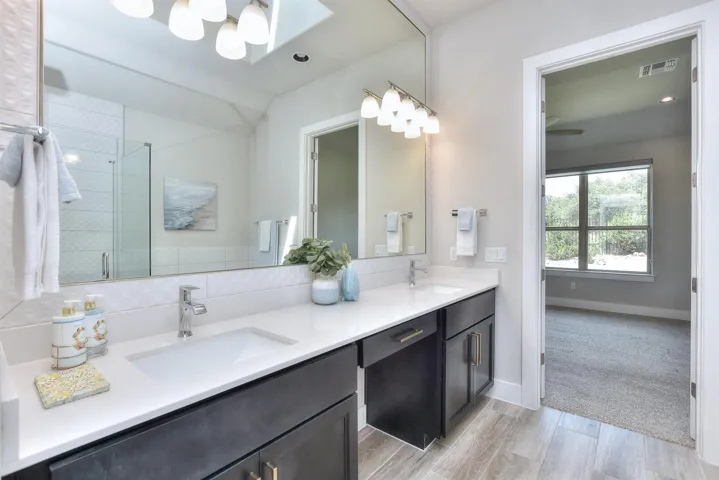 Here's that primary bathroom again...pretty quartz counters with double sink vanities and a makeup vanity.  All cabinets & drawers have designer pulls on them...
