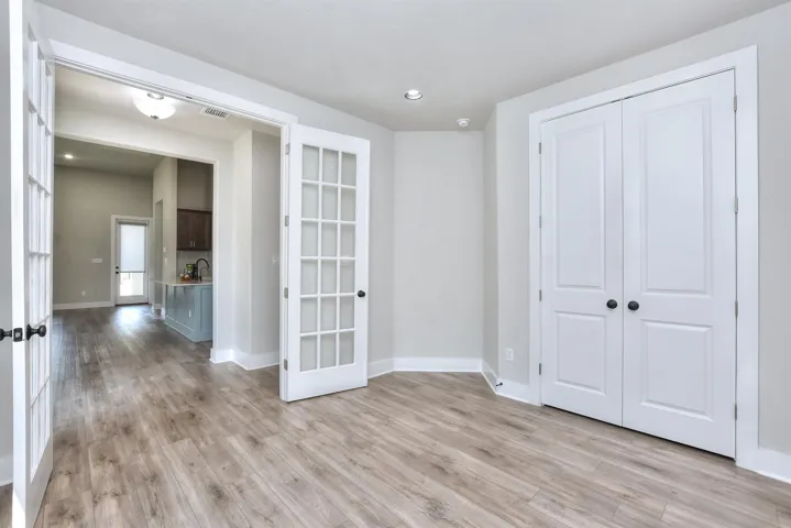 3rd Bedroom inside the home.  This could be used as an office or a bedroom.  Full closet, double windows to exterior on another wall, and French doors....