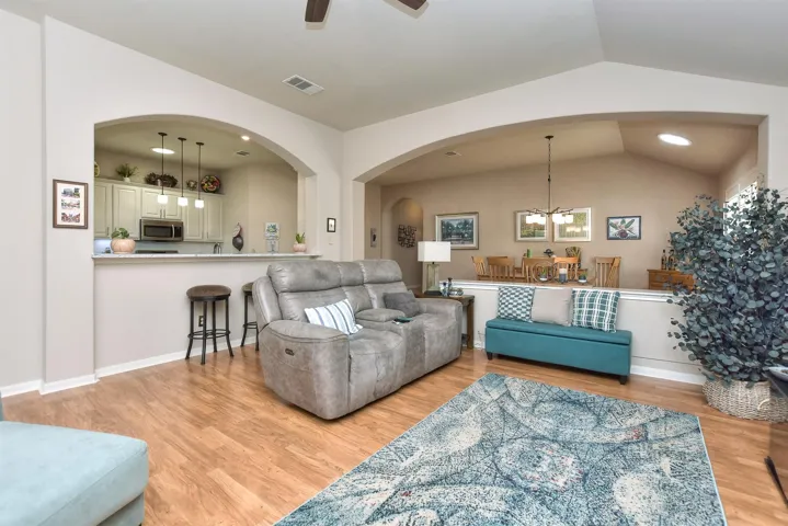 Family room opens to kitchen and formal dining with huge arched openings