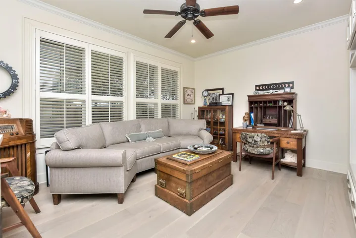 This room is just off of the kitchen.  It is a great flex space to use as it fits YOUR needs.  Currently, it is used as an office/additional room to watch television.  This room CAN be a bedroom if you like.  It has a closet on the far right wall of this photo.  In addition, pretty plantation shutters...