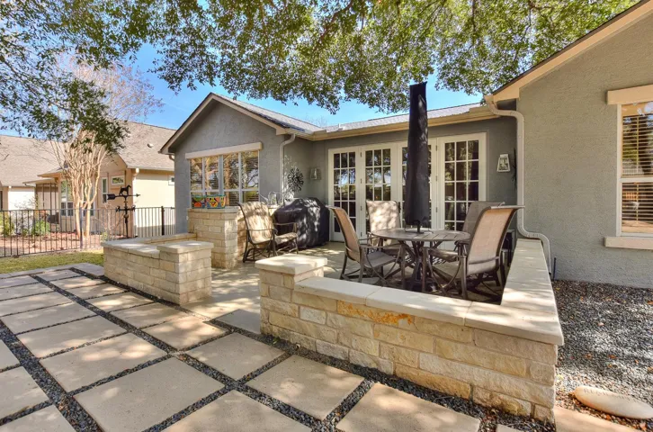 Now let's go outside and relax in the shade of beautiful oak trees.  There is an umbrella in the table that makes this area pop...but we forgot to open it.  Sorry.  You could probably talk the Sellers into leaving it as it is so perfect for this area....Maybe...