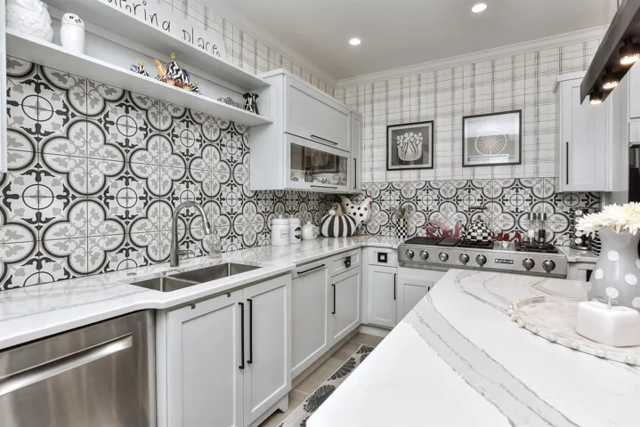 Kitchen was almost completely remodeled...Counter tops replace with marble, all pulls replaced with designer pulls (check out the drawer pulls), backsplash added, wallpaper added, double ovens replaced dishwasher replaced, all flooring replaced....I LOVE this kitchen!!