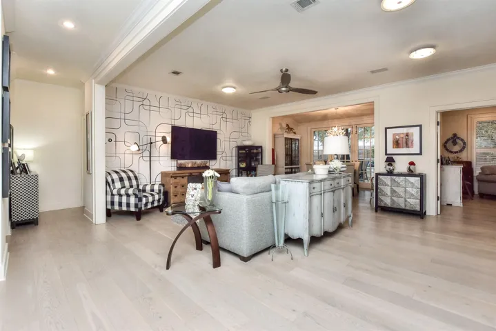 This room is larger than it shows in this photo.  All wood flooring in the home has been replaced...Wallpaper was added, ceiling fan & light fixtures replaced...