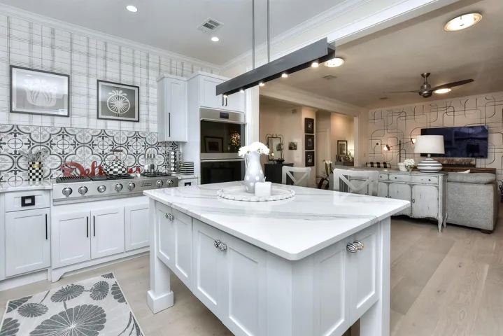 This center island has a breakfast bar on the other side providing company to the chef while they cook.  The top of the center island was replaced with a beautiful slab of marble as well.  Check out the pulls on these storage cabinets in the center island!