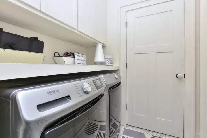Utility room is at the beginning fo the hall leading to the primary suite.