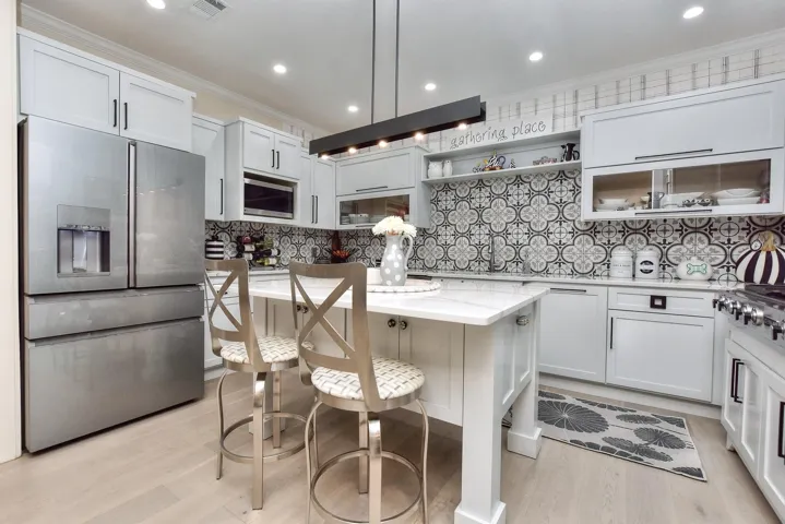 The owners love to cook and love to have visitors sip wine at the breakfast bar here in the center island.  Notice there are even cabinets in the center island in front of the breakfast bar.... Great use of space.  And wait until you see the pantry!