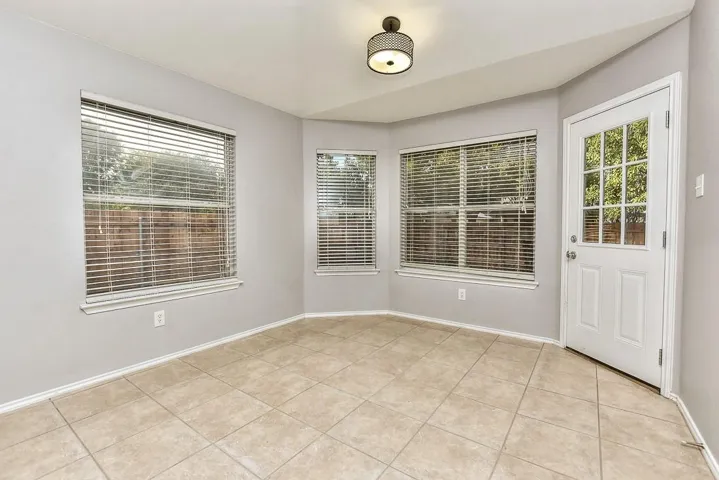 Unfurnished room featuring baseboards and light tile patterned floors
