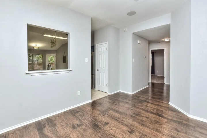 Spare room featuring baseboards and wood finished floors