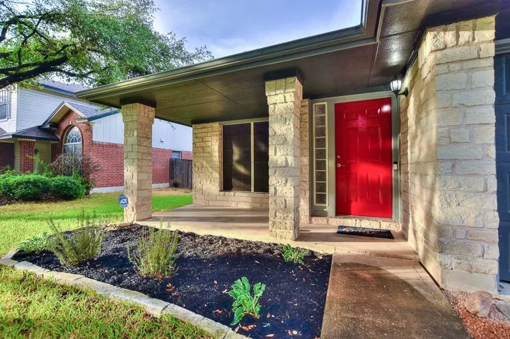 View of exterior entry featuring stone siding