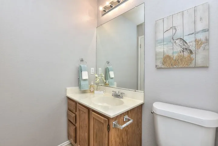 Half bathroom featuring vanity and toilet