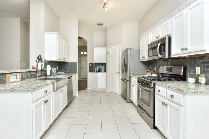 Stainless appliances include gas range, dishwasher, microwave and refrigerator that conveys!