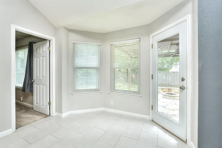 Light, bright dining space with a bay window overlooking the back yard and patio!