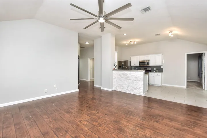 Family room and kitchen open to each other with a breakfast bar in between