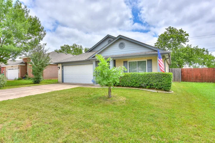 Ranch-style house featuring driveway, an attached garage, and brick siding