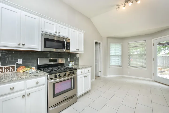This kitchen offers plenty of counter prep space for cooking or baking!