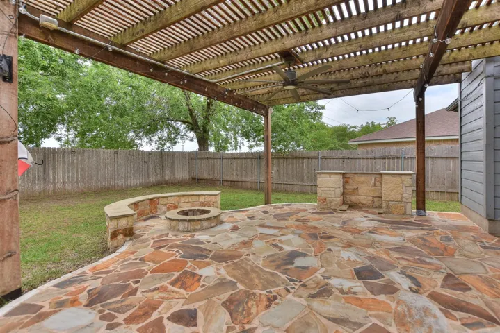 Custom built patio with pergola, built in fire pit and seating PLUS a space to slide in your grill for a custom look!