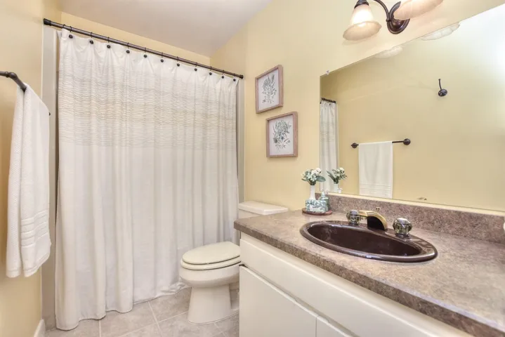 Full bathroom with tile patterned floors, toilet, and vanity
