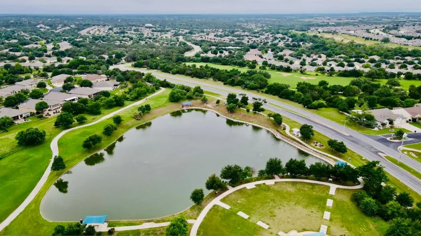 Birds eye view of property featuring a residential view and a water view