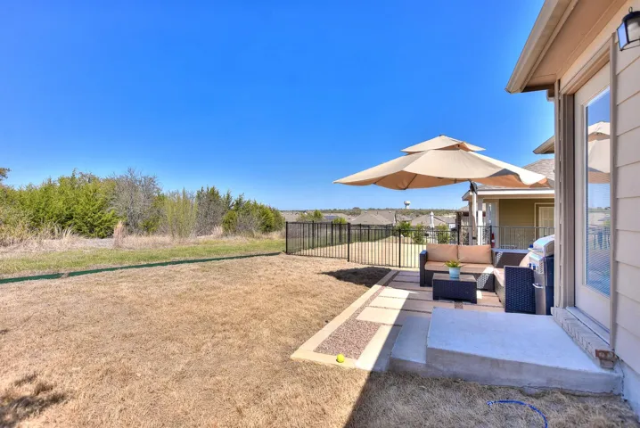 View of yard with an outdoor hangout area and fence