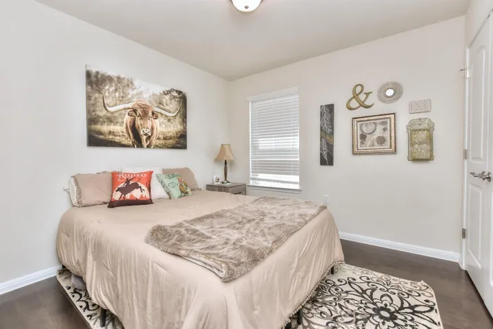 Bedroom featuring wood finished floors and baseboards