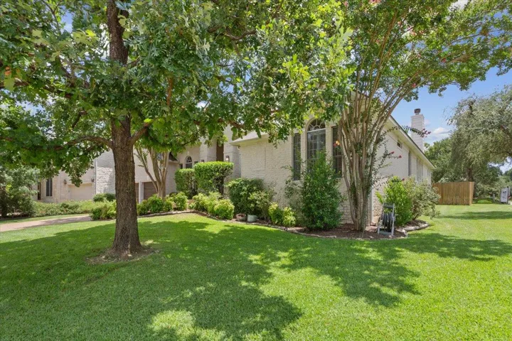 View of front facade with a front yard and a chimney