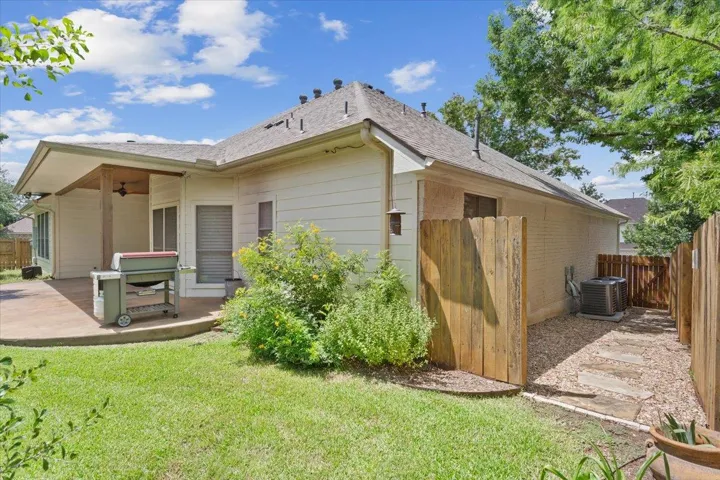 Rear view of house featuring a ceiling fan, a patio, a fenced backyard, and roof with shingles