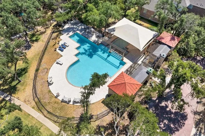 Aerial view of property and surrounding area with a pool area