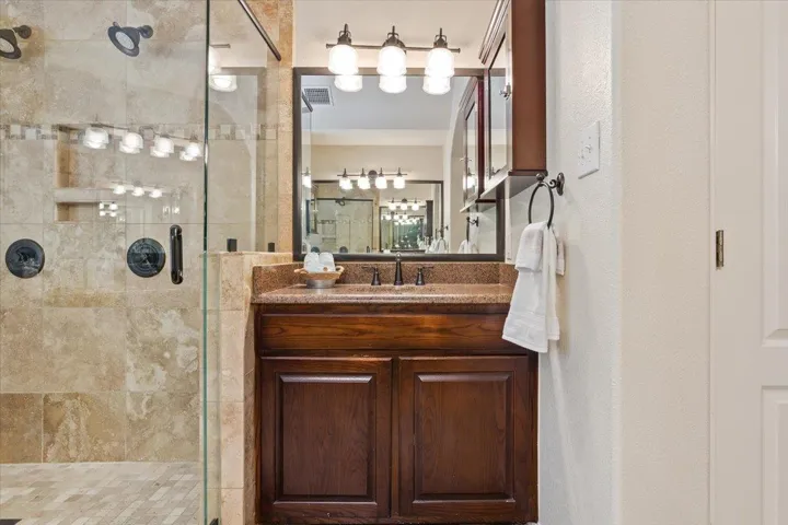 Full bathroom featuring a stall shower and vanity