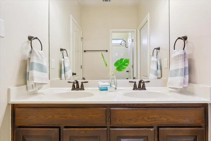 Bathroom with double vanity and a shower