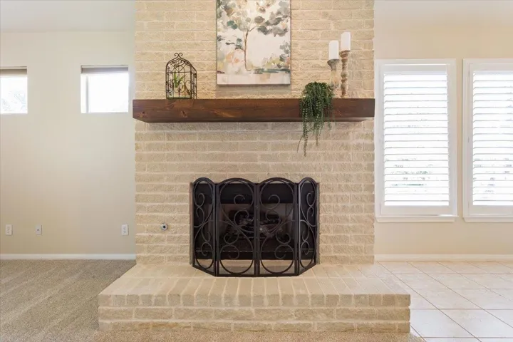 Detailed view of a brick fireplace and baseboards