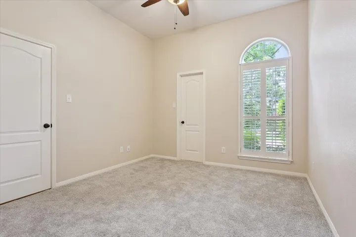 Spare room with a ceiling fan and carpet