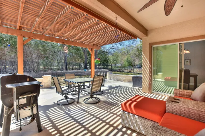 View of patio / terrace featuring a pergola, outdoor dining space, a fenced backyard, and a ceiling fan