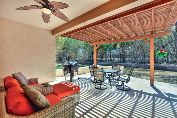 View of patio featuring an outdoor living space, a fenced backyard, outdoor dining space, and a pergola