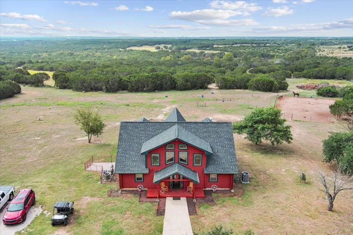 Birds eye view of property featuring a view of trees