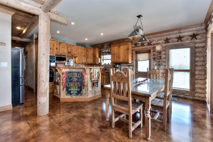 Dining room with plenty of natural light, rustic walls, and recessed lighting