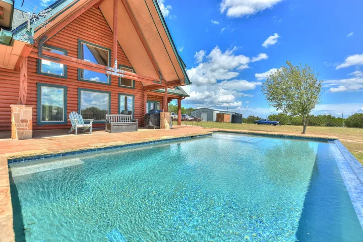 Outdoor pool featuring a patio